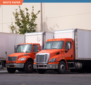 Two freight trucks with orange cabs